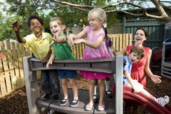 Preschool children on playground with teacher