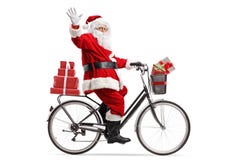 Presentes que llevan de Santa Claus en una bicicleta y agitar fotos de archivo libres de regalías Presentes que llevan de Santa Claus en una bicicleta y agitar fotos de archivo libres de regalías