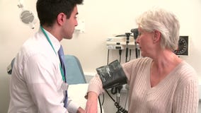 Presión arterial del doctor Taking Senior Female Patient's almacen de video Presión arterial del doctor Taking Senior Female Patient's almacen de video