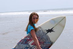 Preteen Girl Carrying A Surfboard To The Ocean Royalty Free Stock Images Preteen Girl Carrying A Surfboard To The Ocean Royalty Free Stock Images