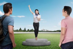 Pretty asian businesswoman giving speech using megaphone to people royalty free stock photos Pretty asian businesswoman giving speech using megaphone to people royalty free stock photos