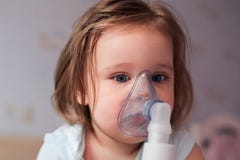 Adorable little girl receives breathing treatment stock image Adorable little girl receives breathing treatment stock image