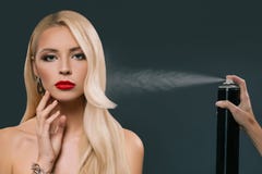 pretty beautiful blonde hair girl with hand using spray Royalty Free Stock Photos pretty beautiful blonde hair girl with hand using spray Royalty Free Stock Photos
