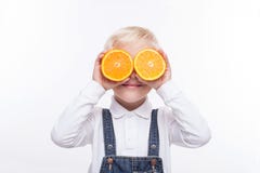 Pretty boy is playing with healthy fruit royalty free stock photo Pretty boy is playing with healthy fruit royalty free stock photo