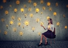 Pretty business woman juggling with light bulbs stock image Pretty business woman juggling with light bulbs stock image