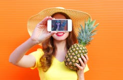 Pretty cool girl with pineapple taking picture self portrait on smartphone stock photos Pretty cool girl with pineapple taking picture self portrait on smartphone stock photos