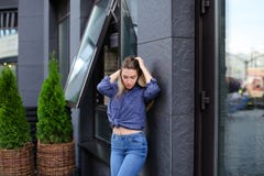 Pretty female model wearing blue shirt and jeans, standing near building. stock images Pretty female model wearing blue shirt and jeans, standing near building. stock images