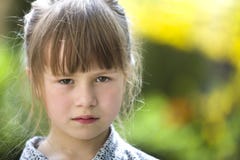 Pretty funny moody young child girl outdoor feeling angry and unsatisfied on blurred summer green background. Children tantrum stock photo Pretty funny moody young child girl outdoor feeling angry and unsatisfied on blurred summer green background. Children tantrum stock photo