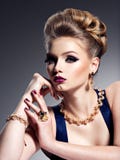 Pretty girl with beautiful hairstyle and gold jewelry, bright m stock images Pretty girl with beautiful hairstyle and gold jewelry, bright m stock images