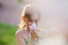 Pretty Girl Smells At Blossom Stock Images