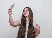 Pretty girl taking selfie on cell phone camera