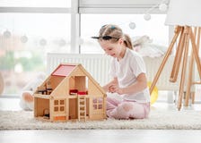 Pretty Little Girl Playing With Dollhouse Stock Photo