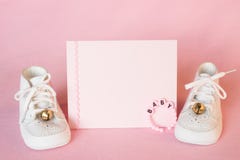 Pretty Pink Baby Girl Shower Invitation Card or Birth Announcement with vintage white shoes on Pink Cloth Background with room or