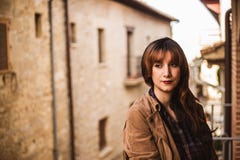 Pretty thoughtful young woman on the balcony in an ancient city royalty free stock image Pretty thoughtful young woman on the balcony in an ancient city royalty free stock image
