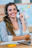 Pretty travel agent smiling at camera Stock Image Pretty travel agent smiling at camera Stock Image