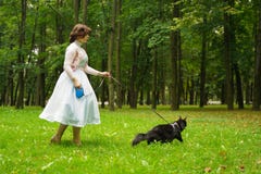 Pretty Vintage Woman Walking With Her Black Cat Maine Coon In The Park Royalty Free Stock Photography