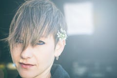 Pretty woman with a flower in her ear royalty free stock photos Pretty woman with a flower in her ear royalty free stock photos