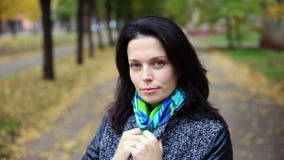 Pretty woman portrait smiling outdoors in the autumn park stock footage Pretty woman portrait smiling outdoors in the autumn park stock footage