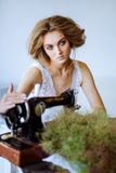 Pretty Woman. In the style of Coco Chanel sitting on a sewing machine stock photo Pretty Woman. In the style of Coco Chanel sitting on a sewing machine stock photo