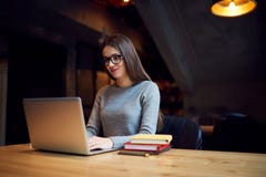 Smart attractive woman reading interesting information and work on modern computer in office.