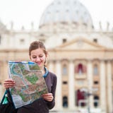 Pretty young female tourist studying a map stock photos Pretty young female tourist studying a map stock photos