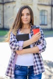 Pretty young smiling cheerful female student in casual clothes h stock photo Pretty young smiling cheerful female student in casual clothes h stock photo