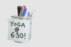 Primer de la nota pegajosa con el mensaje de la yoga en tenedor de la pluma sobre el fondo blanco Fotografía de archivo Primer de la nota pegajosa con el mensaje de la yoga en tenedor de la pluma sobre el fondo blanco Fotografía de archivo