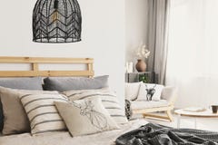 Primo piano del letto comodo con il lotto dei cuscini e di caldo soppressione fotografia stock Primo piano del letto comodo con il lotto dei cuscini e di caldo soppressione fotografia stock