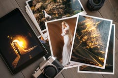 Printed wedding photos with the bride and groom, a vintage black camera and a black tablet with a picture of a wedding Stock Image Printed wedding photos with the bride and groom, a vintage black camera and a black tablet with a picture of a wedding Stock Image