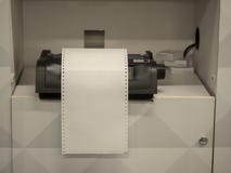 Printer sitting on shelf with overflowing blank white paper stock image Printer sitting on shelf with overflowing blank white paper stock image