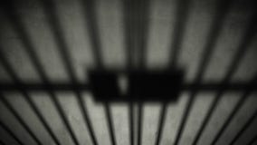 Prison cell door closing shadow on dark concrete jail floor