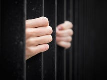 Prisoner behind jail bars Stock Images Prisoner behind jail bars Stock Images