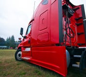 Pro commercial bright red modern semi truck rig side view stock photo Pro commercial bright red modern semi truck rig side view stock photo
