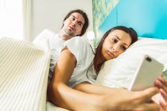 Jealous man spying phone stock photo Jealous man spying phone stock photo