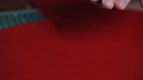 The process of making black handmade leather bag. Craftsman cutting detail with utility knife, close-up shot stock video The process of making black handmade leather bag. Craftsman cutting detail with utility knife, close-up shot stock video