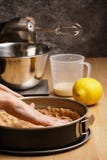 Process of making a delicious lemon cheesecake - spreading dough stock photo Process of making a delicious lemon cheesecake - spreading dough stock photo