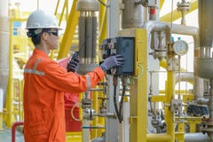 Production operator operating centrifugal oil pump by using local mode to start the pump. stock image Production operator operating centrifugal oil pump by using local mode to start the pump. stock image