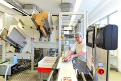 Production of pralines in a factory for the food industry - conveyor belt worker with chocolate royalty free stock photos Production of pralines in a factory for the food industry - conveyor belt worker with chocolate royalty free stock photos