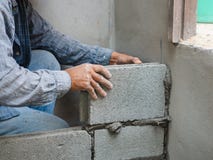 Professional construction worker laying bricks with cement stock photos Professional construction worker laying bricks with cement stock photos