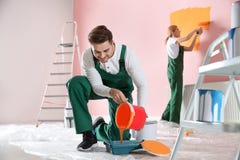 Professional decorator with bucket of paint. Home repair service royalty free stock photos Professional decorator with bucket of paint. Home repair service royalty free stock photos
