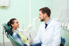 Professional dentist and happy patient in clinic royalty free stock image Professional dentist and happy patient in clinic royalty free stock image