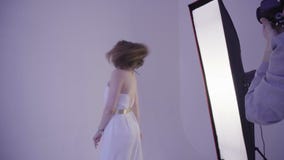 Professional model posing for fashion photographer at fashion photo shoot in studio stock video footage Professional model posing for fashion photographer at fashion photo shoot in studio stock video footage
