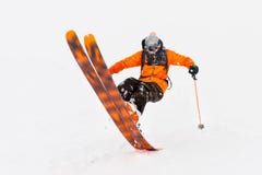 Professional Skier athlete rides out of deep snow while performing a skiing trick in a snowstorm. The winter season is a royalty free stock photography Professional Skier athlete rides out of deep snow while performing a skiing trick in a snowstorm. The winter season is a royalty free stock photography