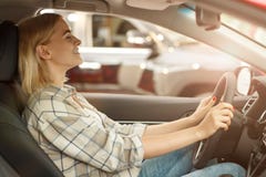 Beautiful young woman buying new car at the dealership royalty free stock photography Beautiful young woman buying new car at the dealership royalty free stock photography