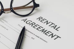 Property or real estate, house and home concept, pen and eyeglasses on rental agreement printed document, ready to sign contract