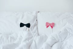 Props with bows for women and men for a stick party lie on the pillows.