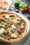 Prosciutto et pizza de pesto avec des tomates-cerises image stock Prosciutto et pizza de pesto avec des tomates-cerises image stock