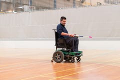 Proud disabled man showing with hockey stick on an electric wheelchair playing sports. IWAS - International wheelchair royalty free stock photos Proud disabled man showing with hockey stick on an electric wheelchair playing sports. IWAS - International wheelchair royalty free stock photos