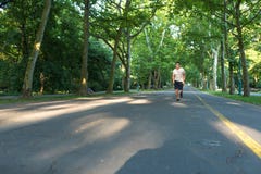 Przystojny młody człowiek jogging w parku obraz stock Przystojny młody człowiek jogging w parku obraz stock