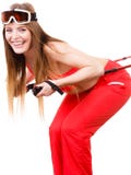 Préparez pour monter le costume de ski de port de femme tenant des poteaux image libre de droits Préparez pour monter le costume de ski de port de femme tenant des poteaux image libre de droits